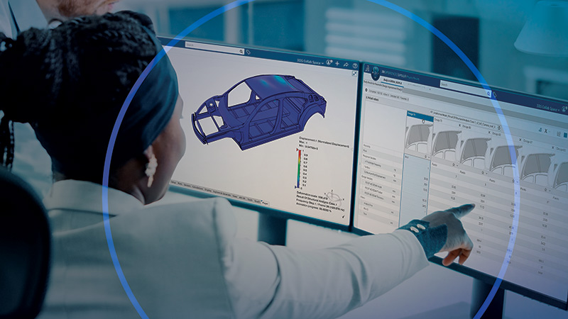 Woman pointing at screen with simulation data for car hood design