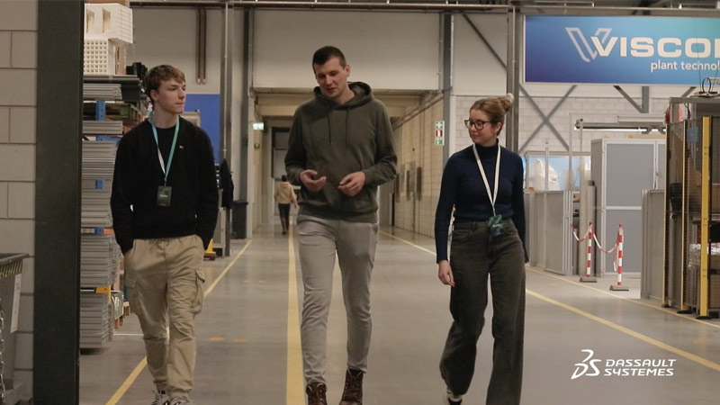 Three employees talking on the manufacturing plant floor