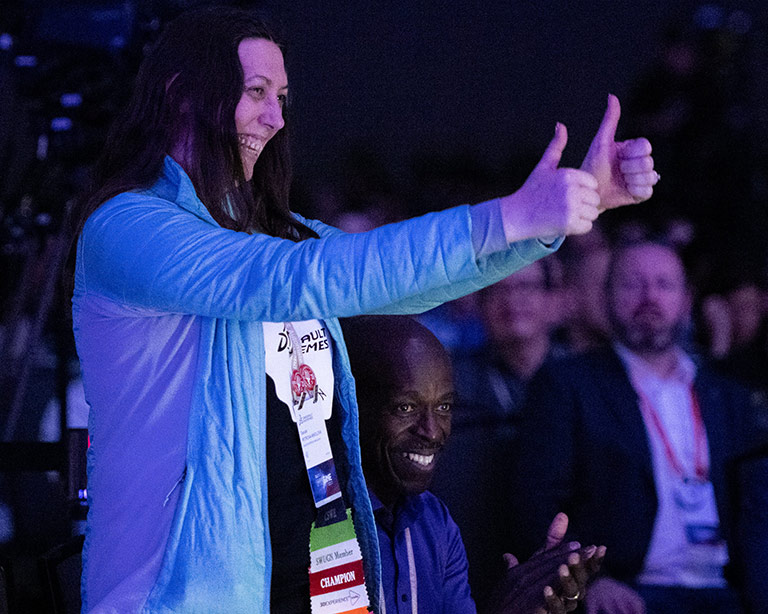 Woman, SOLIDWORKS Champion, standing to be recognized and people applauding 