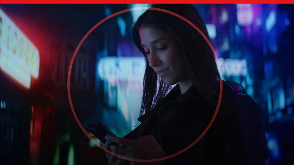 Young woman smiling and looking at a mobile device