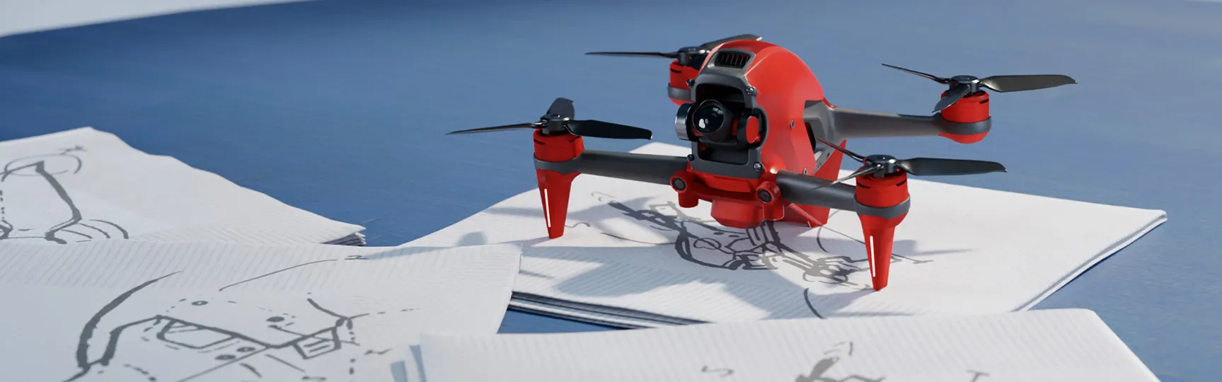 SOLIDWORKS 3D rendering of a drone on top of pen and paper sketches