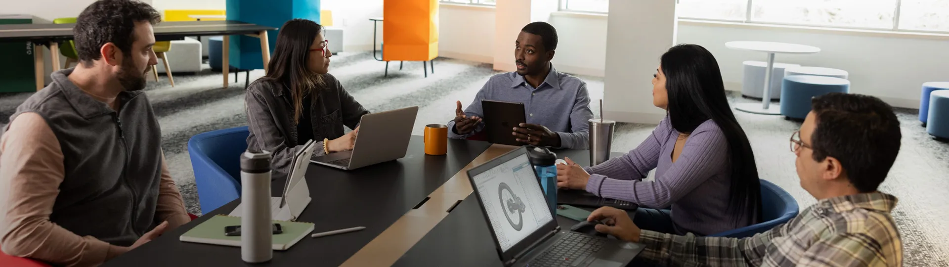 People collaborating around a table - SOLIDWORKS